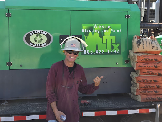 A man in a hard hat standing in front of a truck