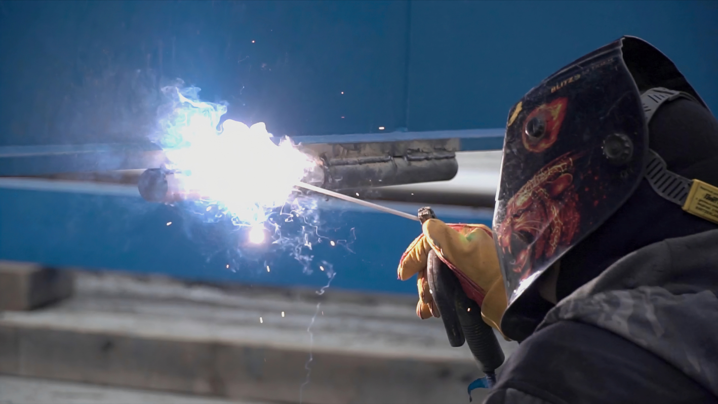 A welder working on a piece of metal